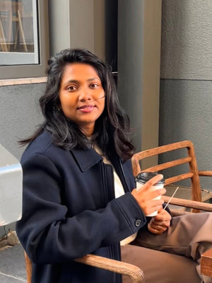 Person sitting at a table in a modern indoor setting